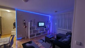 a living room with a purple ceiling with a couch at Apartman Nikola in Žarkovo