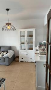 a kitchen with a white cabinet and a couch at blue house cordoba in Córdoba