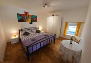 a bedroom with a bed and a table in it at Apartment 22 Omiš in Omiš