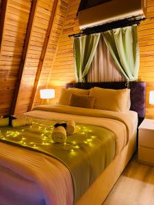 a bedroom with a bed with lights on it at TERRACE BUNGALOW in Kemer