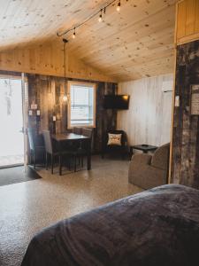 a living room with a table and a couch at Chalet - Abenaki Aventure in Pierreville