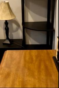 a wooden table with a lamp on top of it at Small private get away, tiny home garage studio apartment in Elizabeth City
