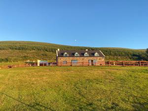 a house in a field with a fence at Valentia View in Portmagee