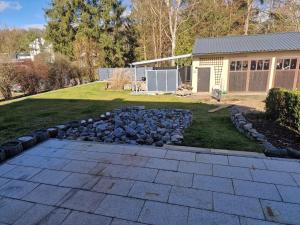 a backyard with a stone walkway and a yard with a house at Berger´s Apartment-Hotel in Grafenwöhr