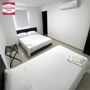 מיטה או מיטות בחדר ב-Hotel bazurto plaza