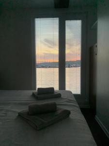 a bedroom with a bed with two towels on it at HOUSE BOAT OLIVA - Floating House in Pula