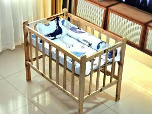 a wooden crib with pillows on top of it at Guest Favorite House in Biñan in Biñan
