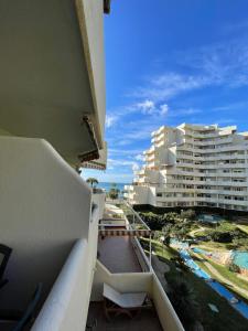 a balcony with a view of a large building at Benal Beach Estudio Playa in Benalmádena