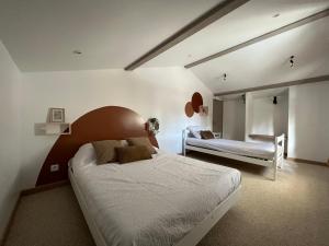a bedroom with a large bed and a mirror at Gîtes du Fanal in Ébéon