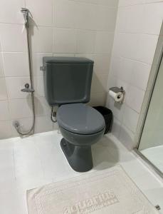 a bathroom with a blue toilet and a shower at AQUARIUS HOTEL in Porto Velho