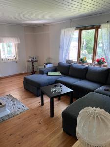 uma sala de estar com um sofá azul e uma mesa em Gotland,Bungeviken em Fårösund