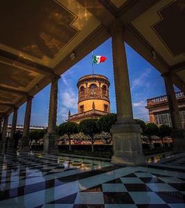 a building with a flag on top of it at Urban Style Retreat, Rooftop Views, CDMX 4 in Mexico City