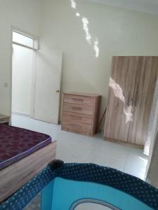 a bedroom with a bed and a dresser at Villa 1428 in Grand Baie