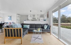 a living room with a couch and a table at Awesome Home In Brovst With Wifi in Brovst