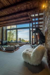 a large living room with a bear statue on the wall at Heartbeat Mountain Escapes in Kato Trikala Korinthias
