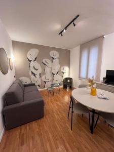 a living room with a couch and a table at Apartment Aurora Rho Fiera in Milan
