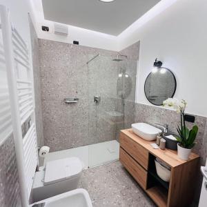 a bathroom with a shower and a toilet and a sink at Apartment Aurora Rho Fiera in Milan