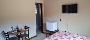 a small room with a table and a small room with a small table at Suíte Com Estacionamento Perto do Centro in Campos do Jordão