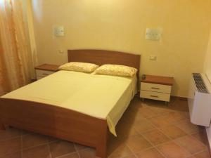 a bedroom with a bed with two pillows on it at Agriturismo La Valbona in San Martino Siccomario