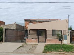 an old house with a gate and a garage at Hospedaje Fliar En Gobernador Gregores in Gobernador Gregores