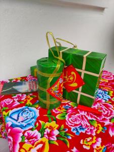 a table topped with two green bags and a table cloth at Boong Home - Pác Bó, Cao Bằng 