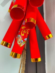 a red ribbon hanging from a window at Boong Home - Pác Bó, Cao Bằng 