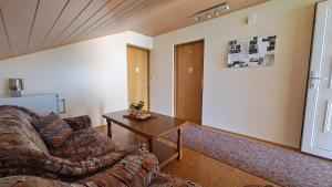 a living room with a couch and a table at Family Puškarić in Slunj