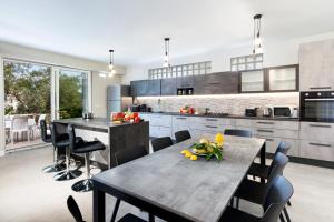 a kitchen with a table and some chairs in it at AMORE RENTALS - Villa Tittina in Sorrento