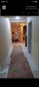 a hallway with a rug on the floor of a room at شقة in Cairo