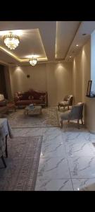 a large living room with couches and a tv at شقة in Cairo