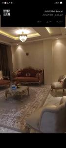a living room with a couch and a coffee table at شقة in Cairo