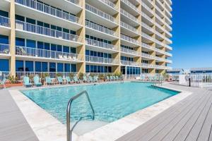 a swimming pool in front of a building at Sanibel 903 in Gulf Shores