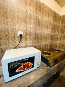 a microwave sitting on a counter next to a toaster at Entire place- Ac 2BHK Apartment Basundhara R/A in Dhaka