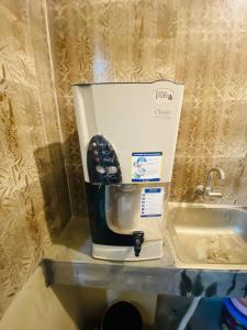 a coffee maker sitting on a counter next to a sink at Entire place- Ac 2BHK Apartment Basundhara R/A in Dhaka