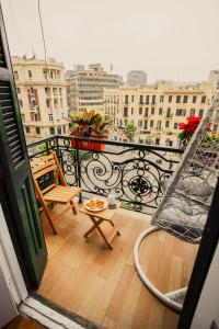 a balcony with a table and chairs on a balcony at The Square Boutique Hotel in Cairo
