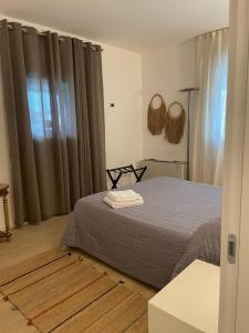 a bedroom with a bed and a window with curtains at Casa D'Angelo con parcheggio in Vicenza +14 photos