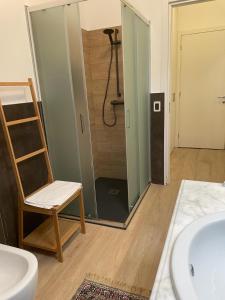 a bathroom with a chair next to a shower at Casa D'Angelo in Vicenza