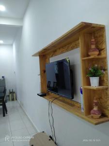 a television on a shelf on a wall at BONDA ROSNAH HOMESTAY in Arau