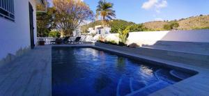 a swimming pool in a house with blue water at Mostalla de jaume in Pego