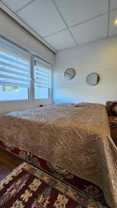 a large bed in a room with two windows at Orientalische Wohnung in Meckenheim