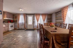a kitchen and dining room with a table and chairs at Rustic Villa Country Getaway in Saint-Gabriel-de-Brandon