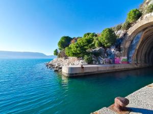 a bridge over the water next to a body of water at Vila DoLaNi in Klek