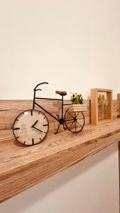 a bike sitting on a shelf with a clock at Comfort Place Brno Apartments in Brno +10 photos
