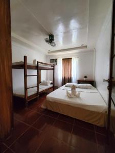 a bedroom with two bunk beds in a room at Ricardo Valley Inn in Coron