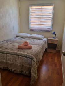 a bedroom with a bed with a towel on it at Departamentos Arlenne in Valdivia