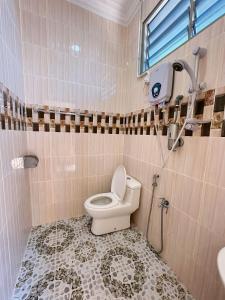 a bathroom with a toilet and a sink at Fiqthya Chalet & Cafe in Tioman Island