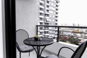 a table and chairs on a balcony with a view at JD Luxury Apartments 2 in Vlorë