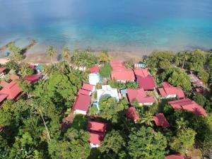 an aerial view of a resort with red roofs and the ocean at Fiqthya Chalet & Cafe in Tioman Island