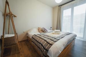 ein Schlafzimmer mit einem Bett und einem großen Fenster in der Unterkunft Vacation home Khatosi in Oni