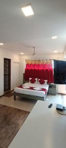 a bedroom with a large bed with a red headboard at New Phoenix By Glitz Hotels in Navi Mumbai